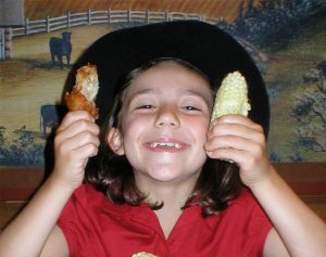 Happy kid eating at Miller's Smorgasbord